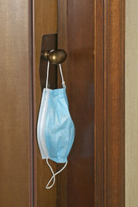 Close-up of clothes hanging on wooden door