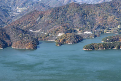 Scenic view of sea and mountains against sky