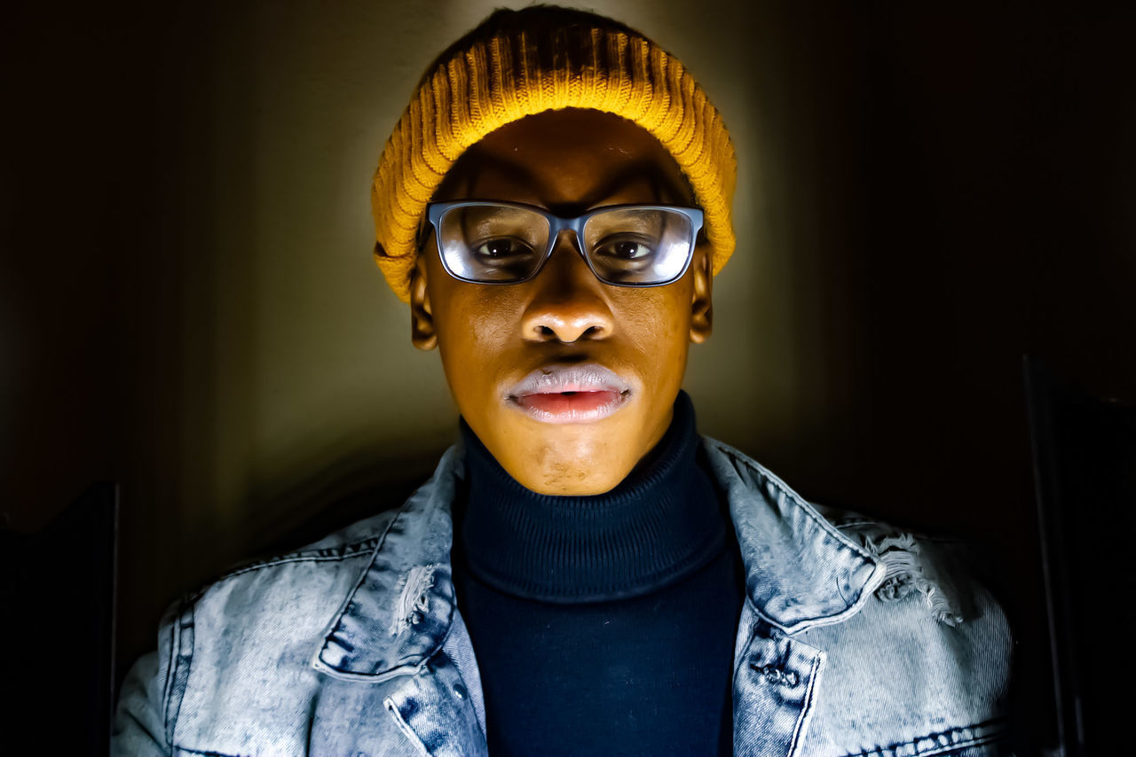 portrait, one person, glasses, adult, headshot, indoors, front view, looking at camera, clothing, person, fashion, young adult, human face, cool attitude, vision care, blue, eyeglasses, men, smiling, emotion, casual clothing, individuality, human head, arts culture and entertainment, sunglasses, lifestyles