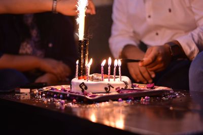 Cutting birthday cake on table