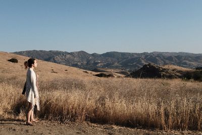 Man on field against clear sky