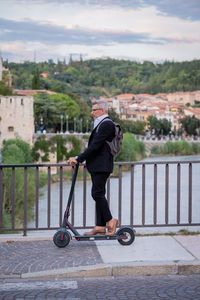 Side view of man cycling on railing