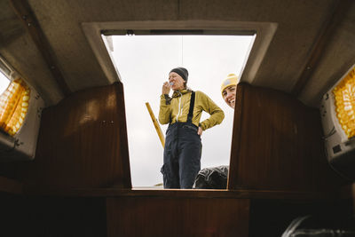 Smiling women at entrance to boat cabin