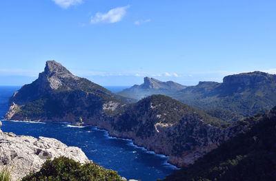 Scenic view of mountains against blue sky