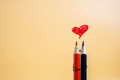 Close-up of red heart shape over white background