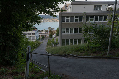 Residential building by road against sky