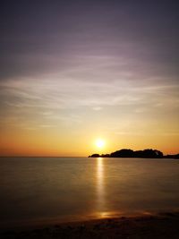Scenic view of sea against romantic sky at sunset