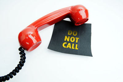 Close-up of telephone booth against white background