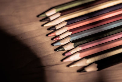 Sunlight falling on colored pencils at table