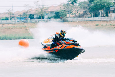 People riding motor boat in water