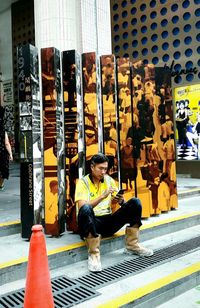 Man sitting in shopping cart