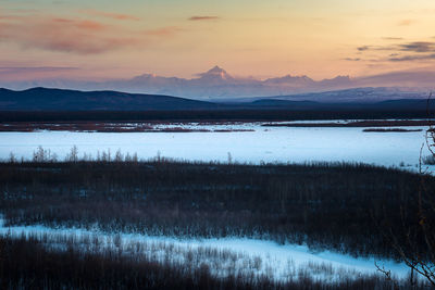 Scenic view of lake against sky during sunset