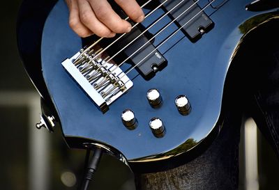 Close-up of man playing guitar