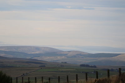 Scenic view of landscape and mountains against sky