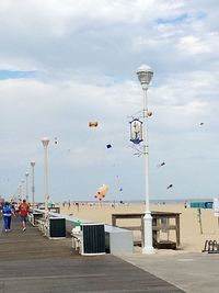 Street lights on beach against sky