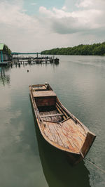 Boats moored in lake against sky