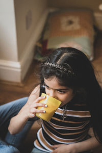 Cute girl drinking milk at home