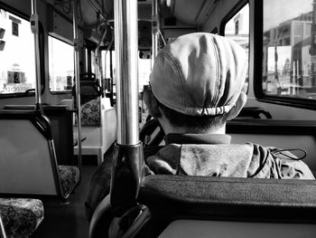 Close-up rear view of man in bus