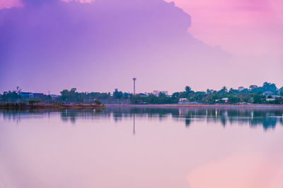 Scenic view of lake against clear sky at sunset