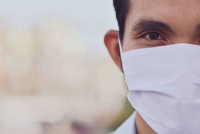 Close-up portrait of mid adult man wearing mask