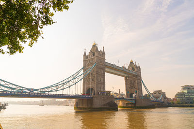 View of bridge over river against cloudy sky