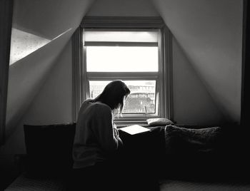 Woman by window at home