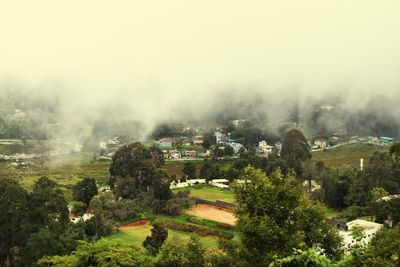 High angle view of trees and buildings against sky