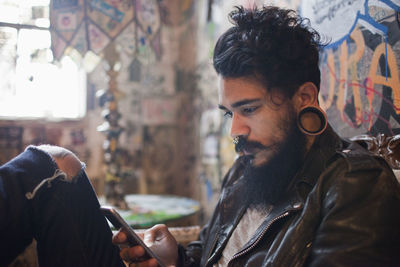 Young man looking through mobile phone