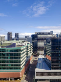 Modern buildings in city against sky