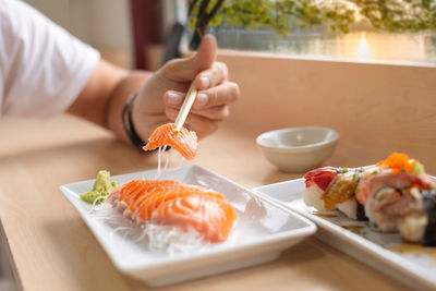 Midsection of sushi served on table