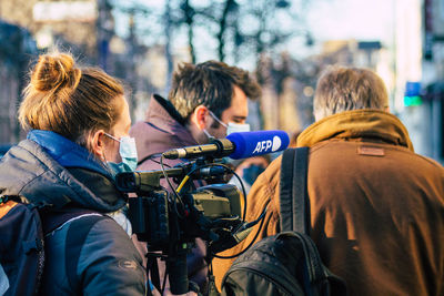 Rear view of people photographing