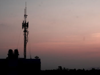 Silhouette tower against sky during sunset