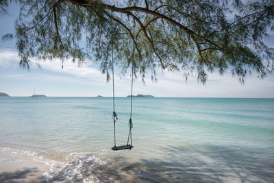 Scenic view of sea against sky. swing over sea