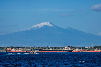 Scenic view of sea and mountains against sky