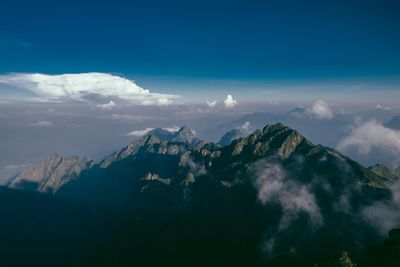 Panoramic view of mountains against blue sky