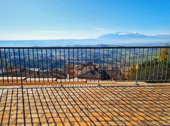 Shadows of the railing stretch over the abruzzo landscape