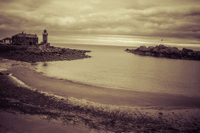 Scenic view of beach by sea against sky