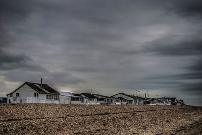 Houses on field against sky