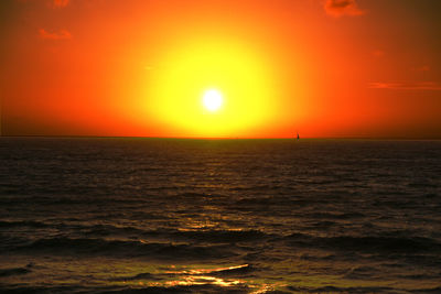 Scenic view of sea against orange sky