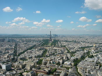 High angle view of eiffel tower amidst city against sky