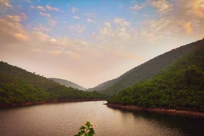 Scenic view of river amidst mountains against sky