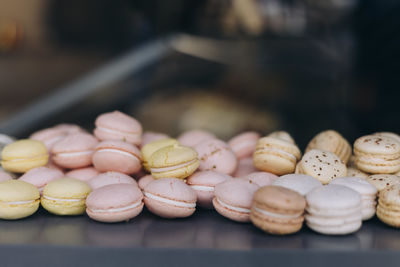 Pastel colored macarons in a shop window in paris, france