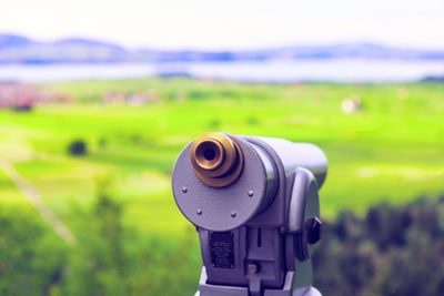 Close-up of camera on field against sky