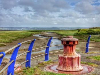 Scenic view of landscape against cloudy sky