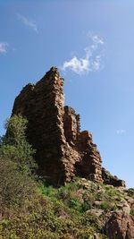 Low angle view of rock formations against sky