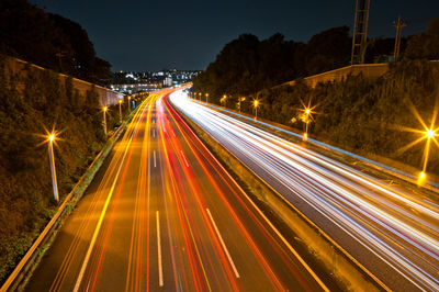 High angle view of light trails on road at night