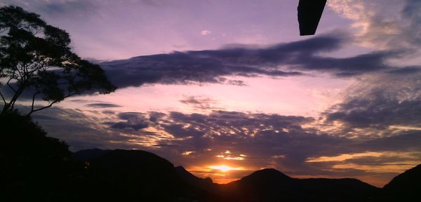 Silhouette of mountain range at sunset