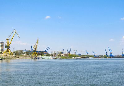 Commercial dock by sea against sky