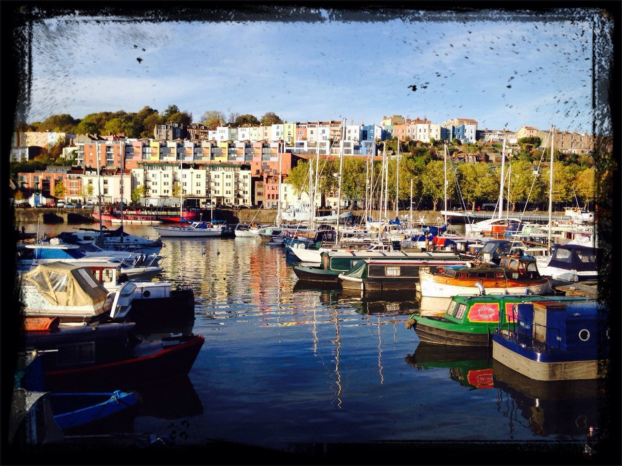 nautical vessel, moored, boat, water, transportation, mode of transport, building exterior, architecture, built structure, waterfront, harbor, reflection, transfer print, auto post production filter, city, sky, in a row, travel, day, outdoors