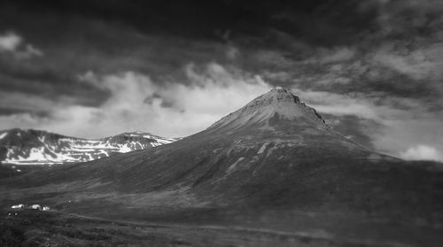 Scenic view of mountains against cloudy sky